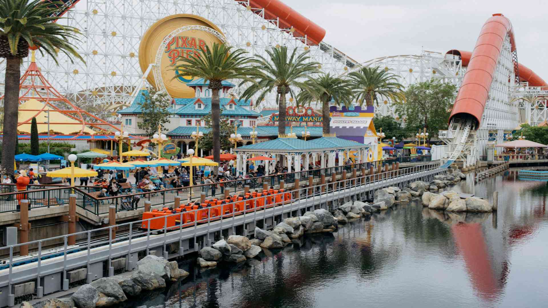 a-roller-coaster-ride-next-to-a-body-of-water